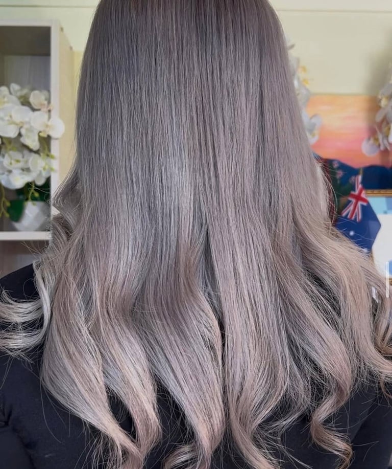 Back view of long gray hair with soft waves and layers, styled with a full voluminous look
