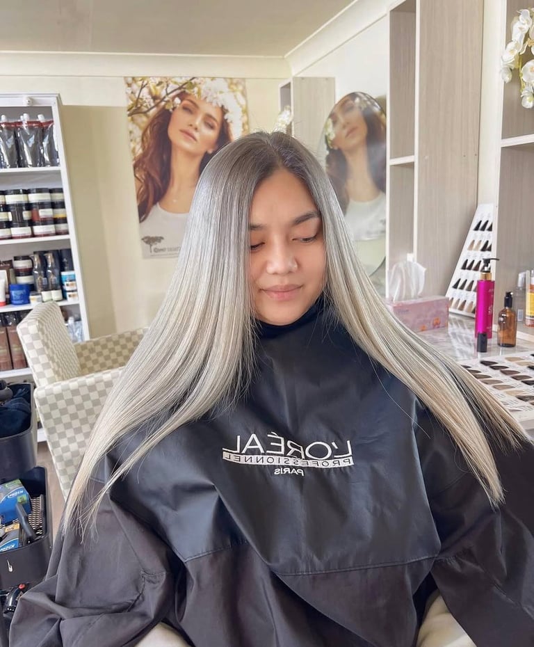 Woman with long straight gray hair in a salon